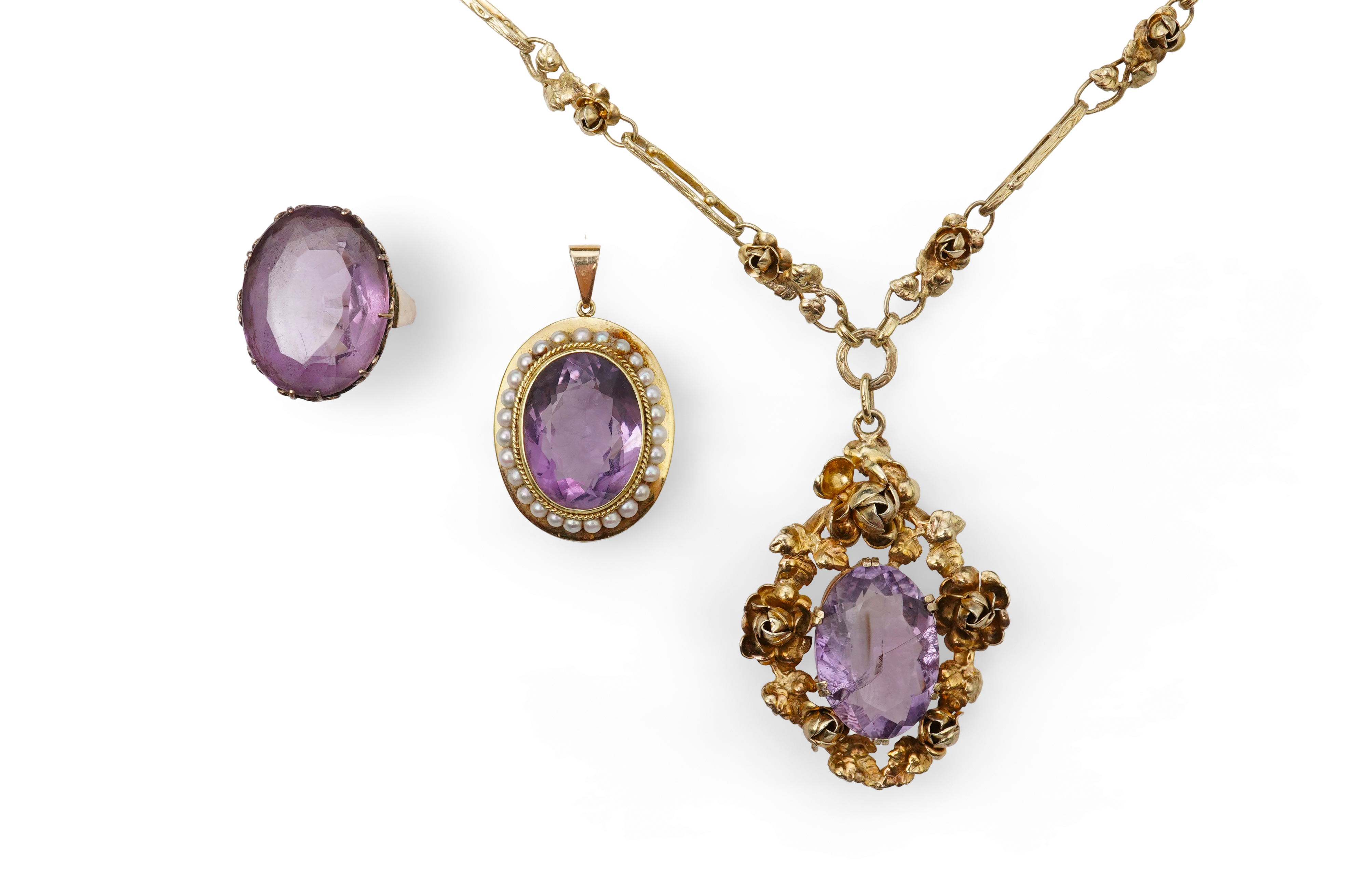 An amethyst ring, necklace and pendant, comprising: an oval amethyst set in a floral gilt silver necklace, length 32cm; an oval amethyst and seed pearl pendant, length 3.7cm; and a ring set with an oval amethyst, mounted